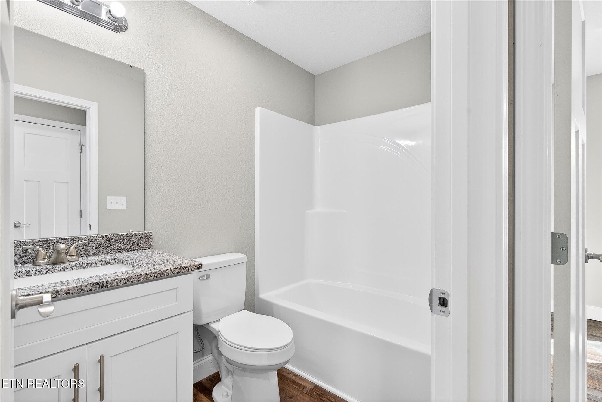 1311 Cook Road Crossville, TN 38555 - Photo 16 of 32 a bathroom with a sink toilet vanity and shower