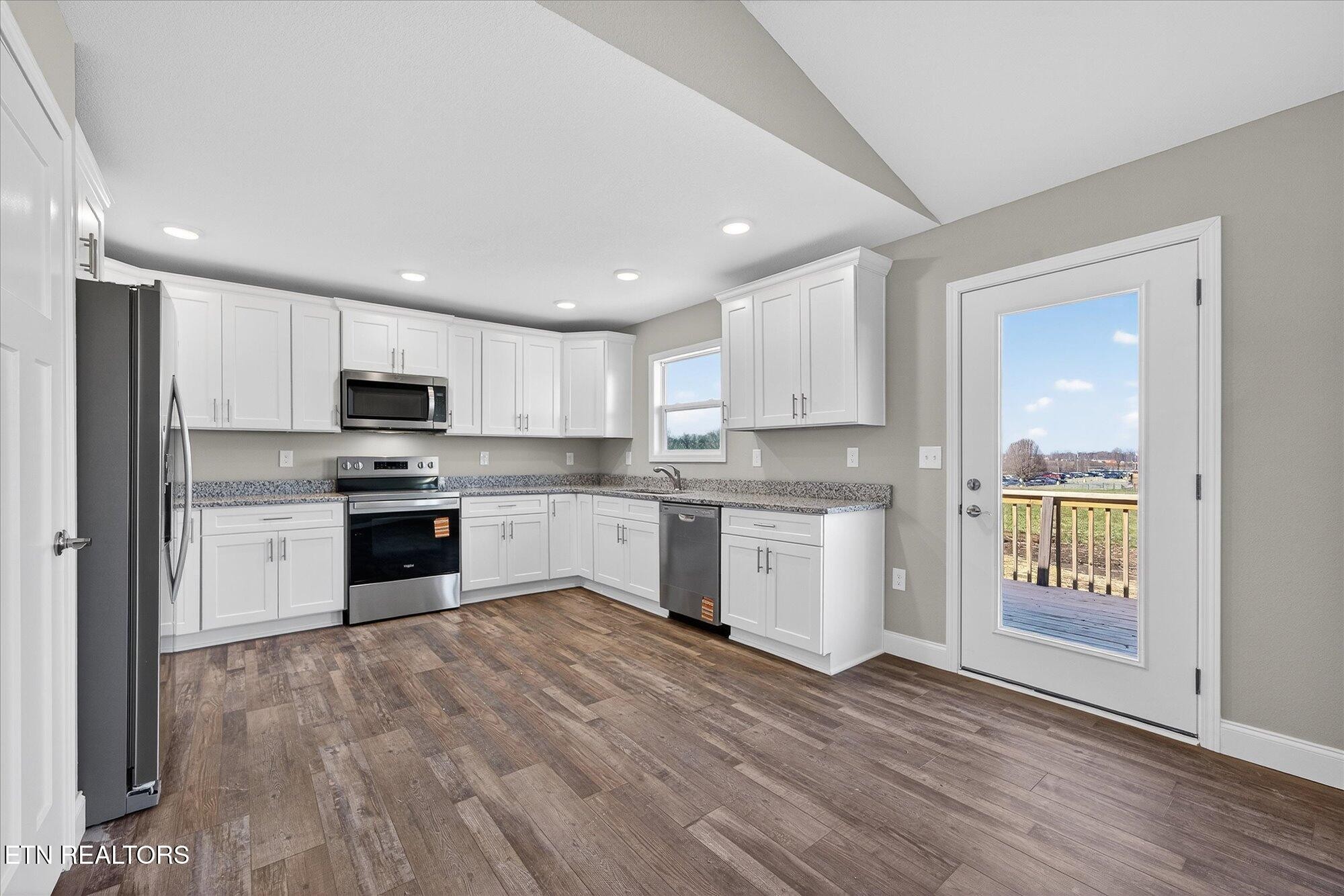 1311 Cook Road Crossville, TN 38555 - Photo 6 of 32 a kitchen with a refrigerator and a stove top oven