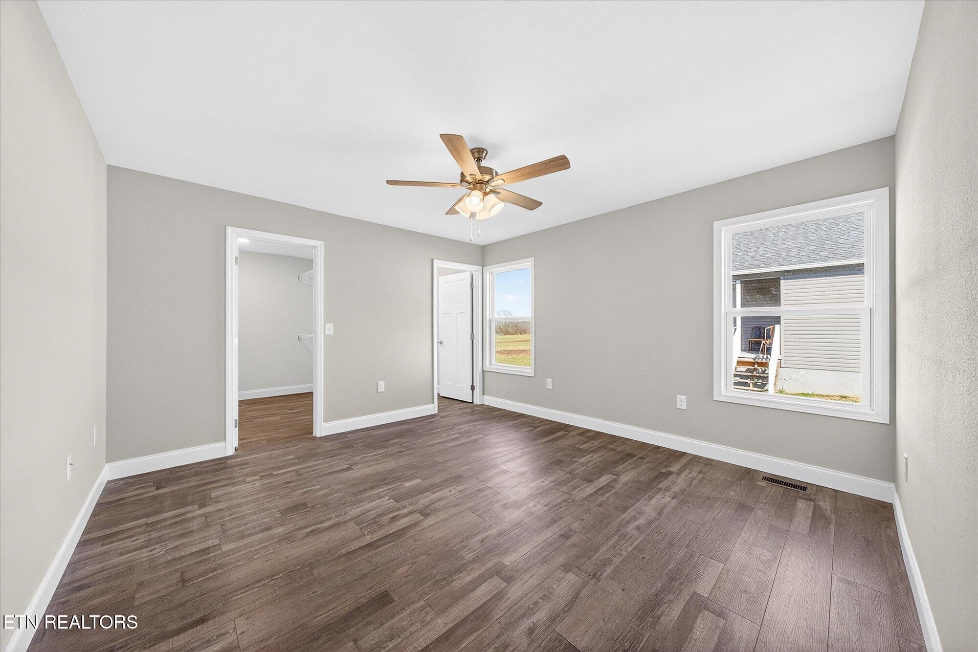 1311 Cook Road Crossville, TN 38555 - Photo 10 of 32 an empty room with wooden floor and windows
