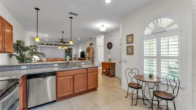 a kitchen with stainless steel appliances granite countertop a stove a sink and a wooden floors