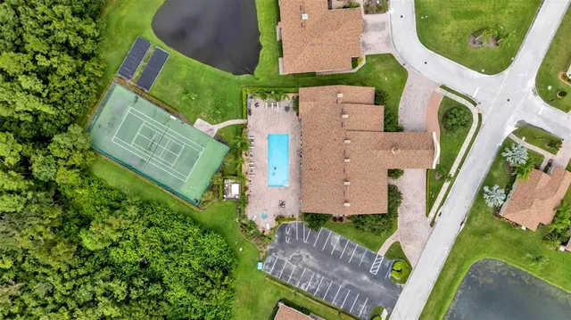 an aerial view of a house with garden space and street view
