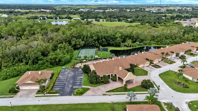an aerial view of house with yard swimming pool and outdoor seating