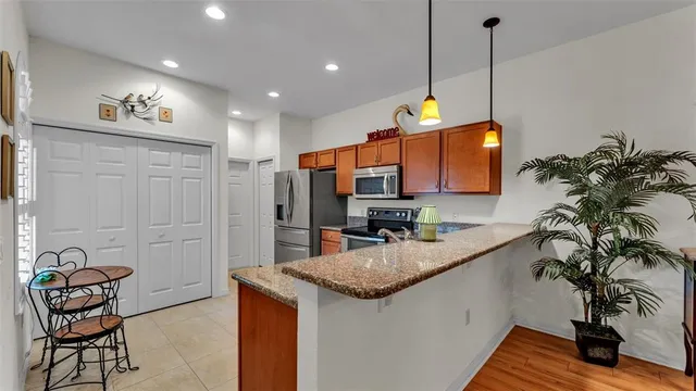 a kitchen with granite countertop a sink a counter top space and living room area