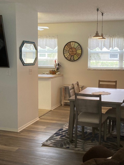 a view of a dining room with furniture and window