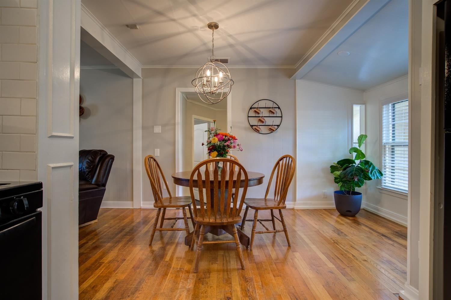 2714 29th Street Lubbock, TX 79410 - Photo 13 of 35 a view of a dining room with furniture wooden floor and chandelier