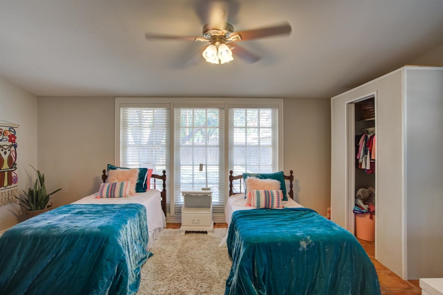 2714 29th Street Lubbock, TX 79410 - Photo 17 of 35 a bed room with a bed and a chandelier