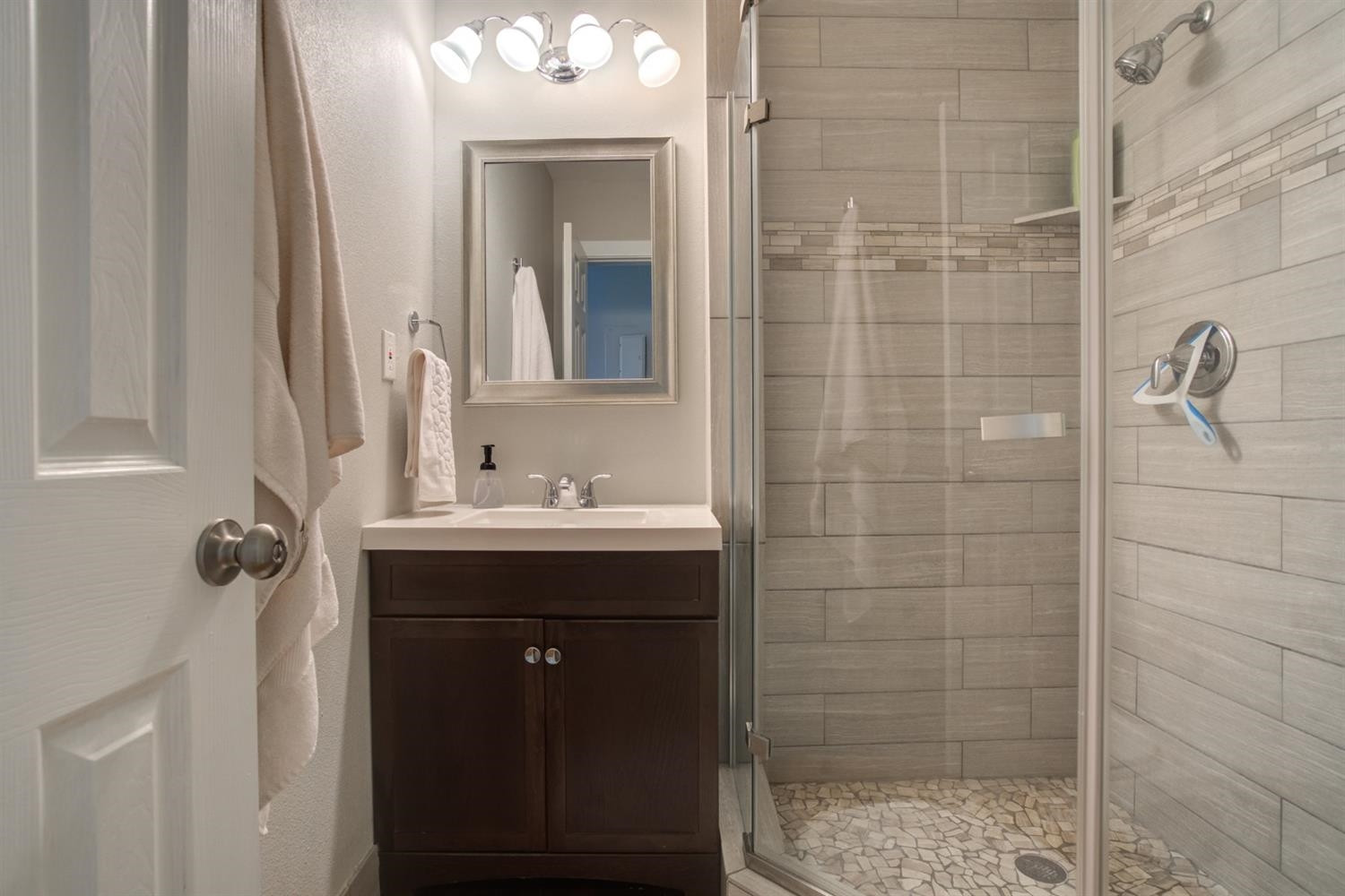 2714 29th Street Lubbock, TX 79410 - Photo 19 of 35 a bathroom with a sink and mirror