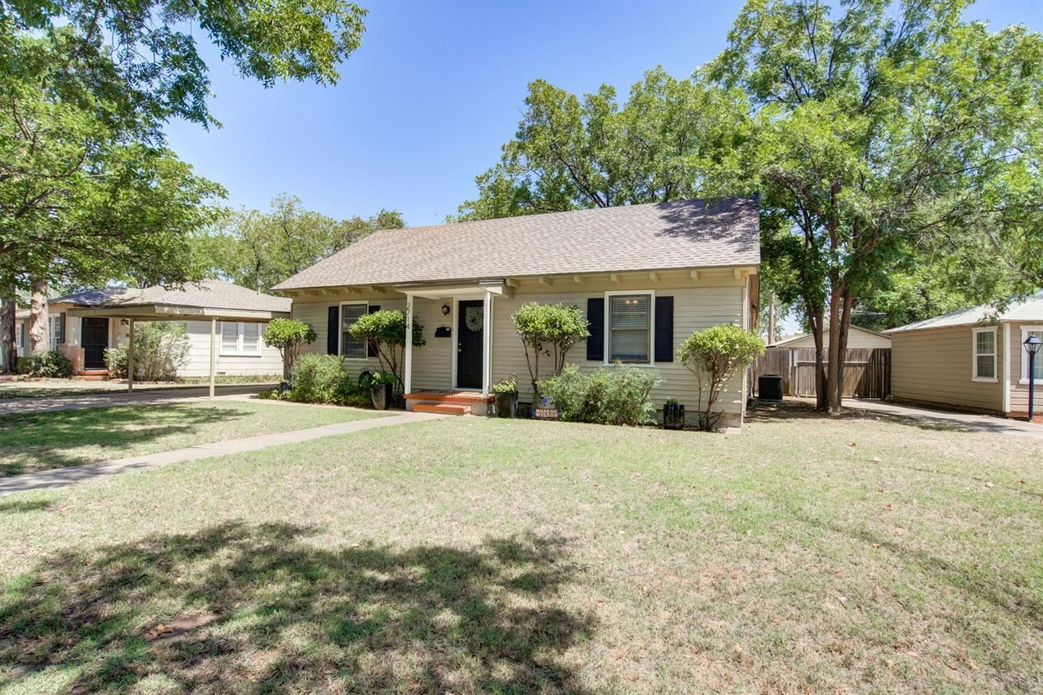 2714 29th Street Lubbock, TX 79410 - Photo 2 of 35 a front view of a house with a garden