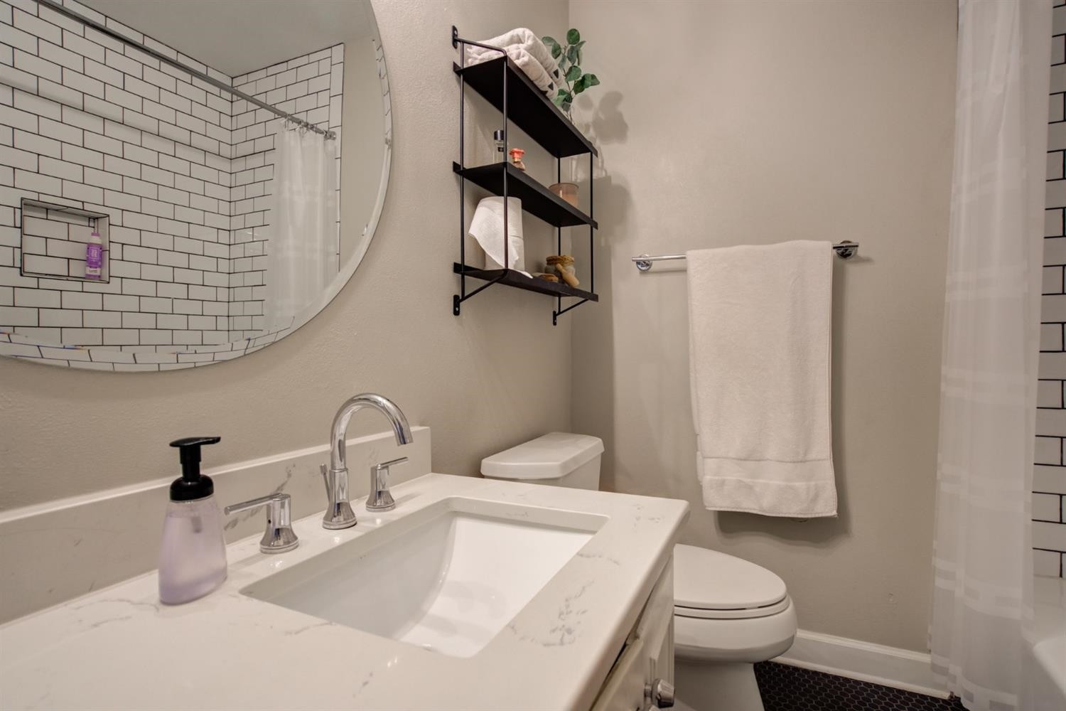 2714 29th Street Lubbock, TX 79410 - Photo 22 of 35 a bathroom with a sink a toilet and shower curtain