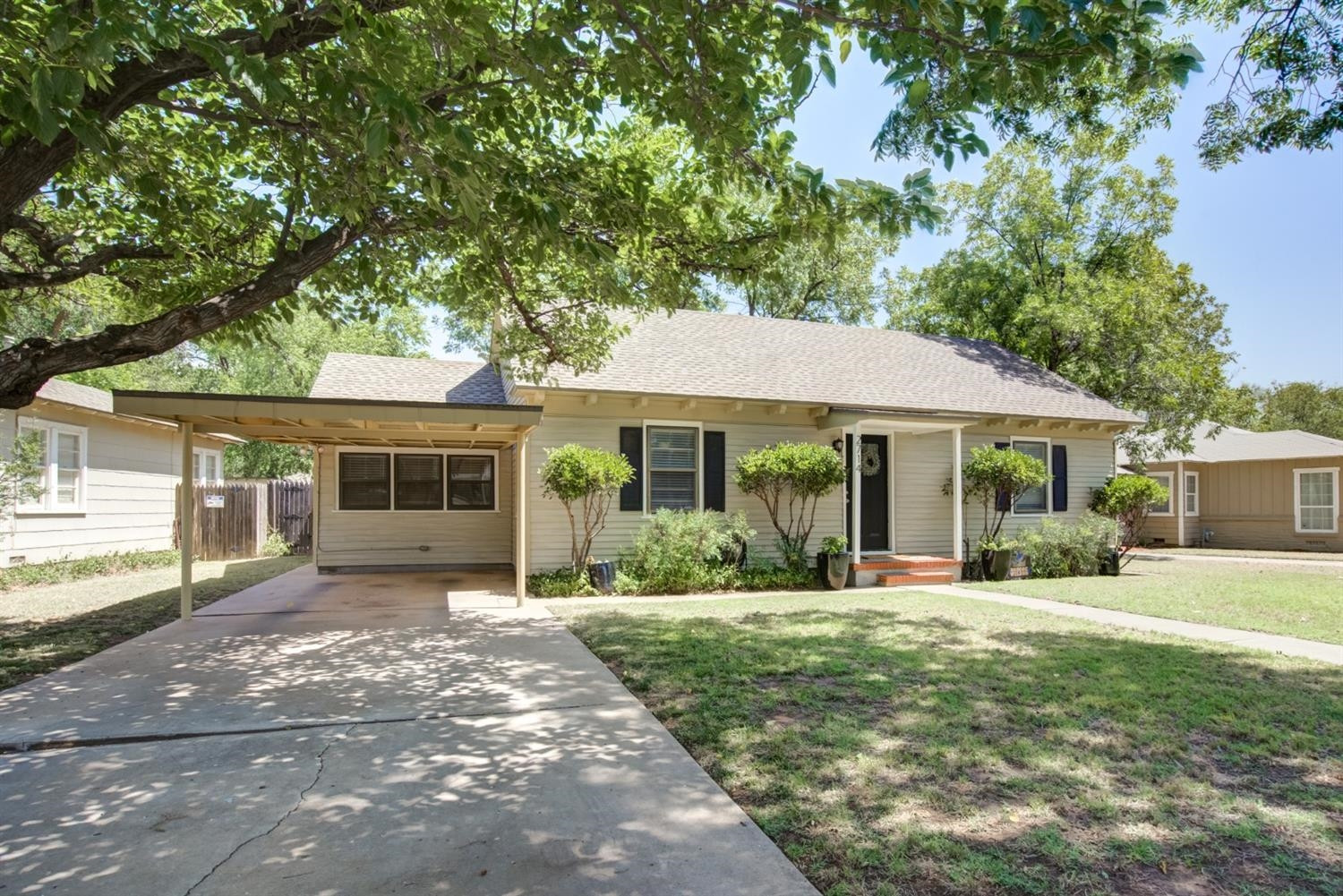 2714 29th Street Lubbock, TX 79410 - Photo 3 of 35 a front view of a house with yard and green space