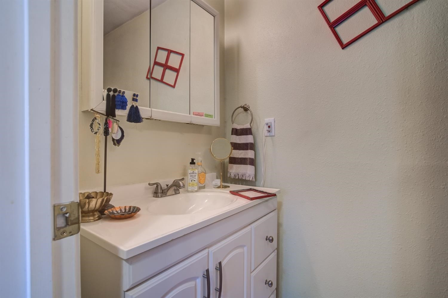 2714 29th Street Lubbock, TX 79410 - Photo 31 of 35 a bathroom with a sink and a mirror