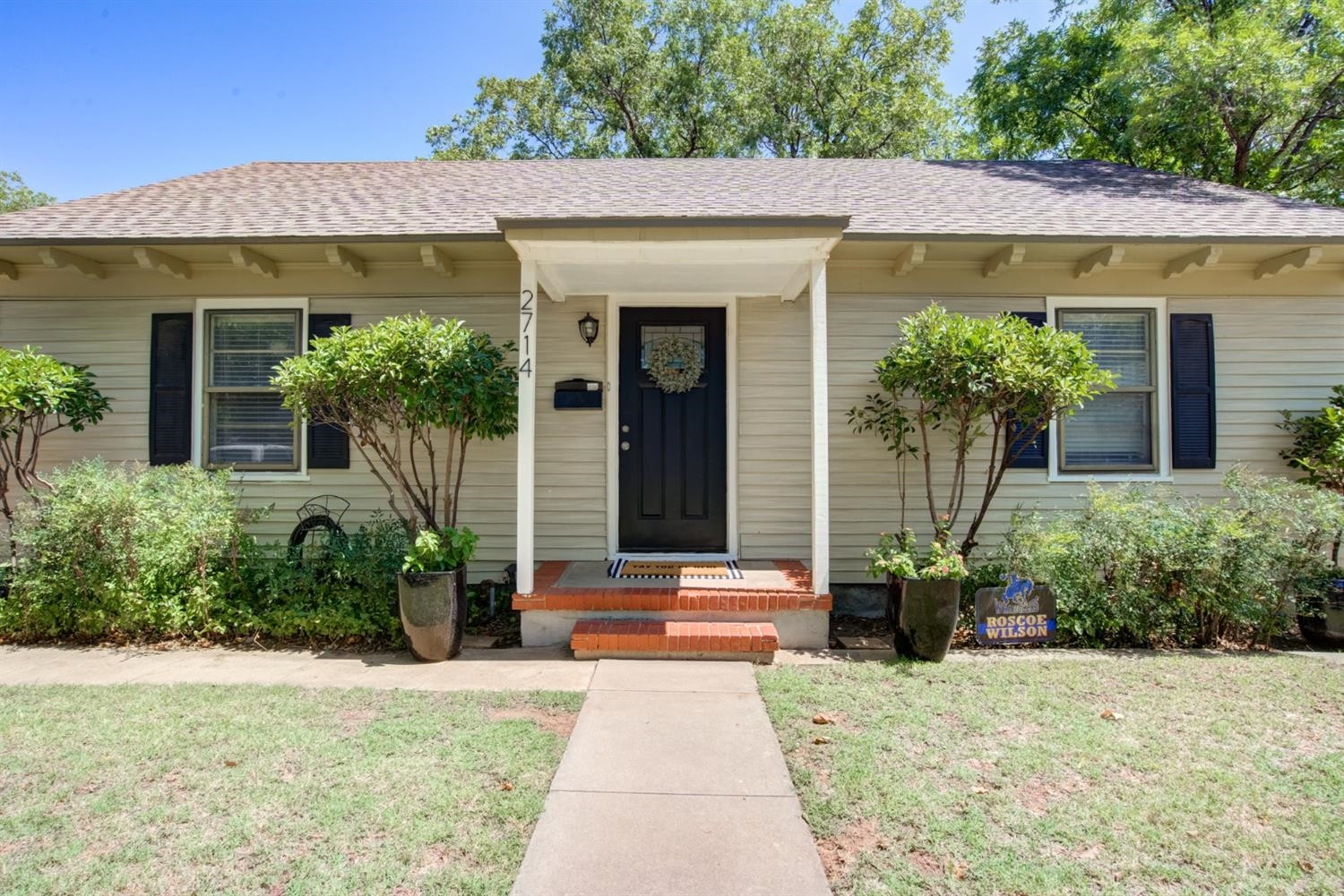 2714 29th Street Lubbock, TX 79410 - Photo 4 of 35 a front view of a house with potted plants