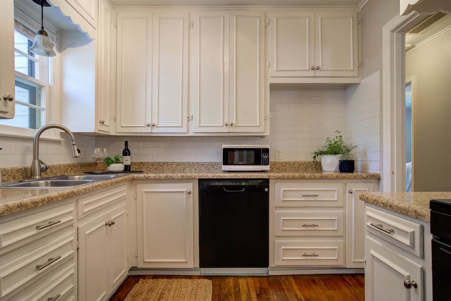 2714 29th Street Lubbock, TX 79410 - Photo 10 of 35 a kitchen with granite countertop white cabinets and appliances