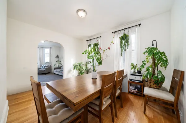 a view of a dining room with furniture and wooden floor