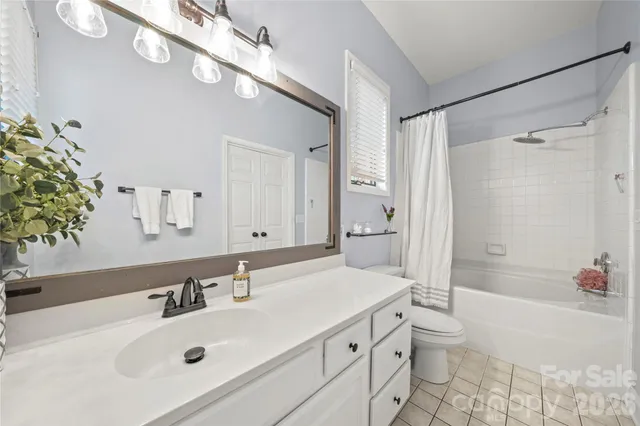 a bathroom with a sink vanity granite tub and shower