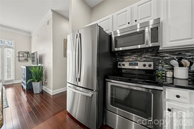 a kitchen with appliances a microwave and cabinets