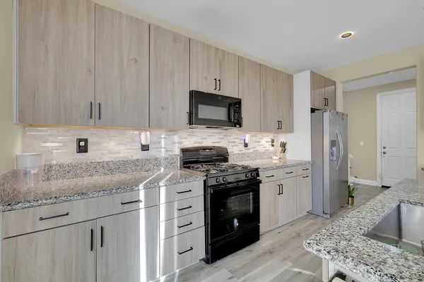 a view of a room with wooden floor and windows