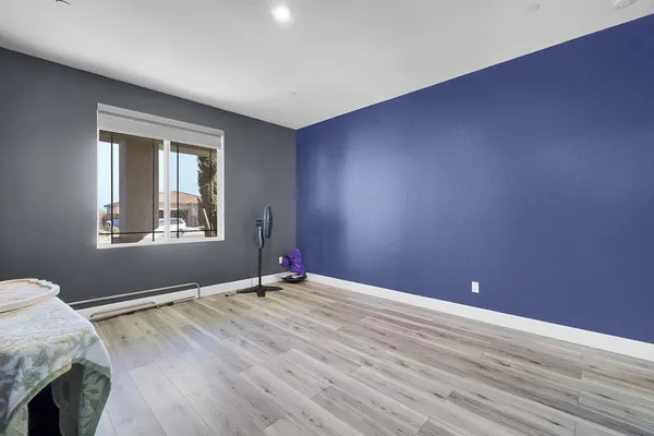 a view of a room with wooden floor