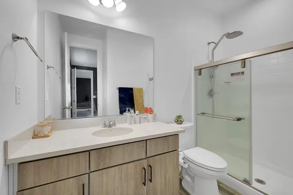 a bathroom with a sink toilet and shower