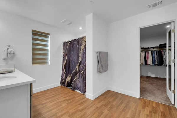 a bathroom with a sink a mirror and a window