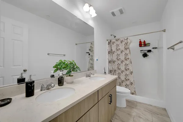 a bedroom with a bed and a chair