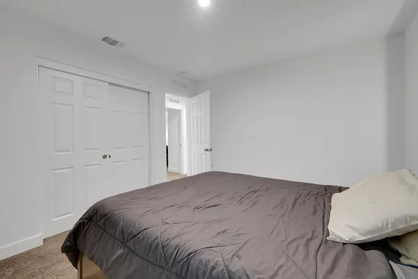 a bedroom with a bed and a mirror