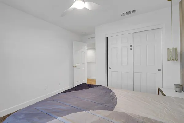 a living room with furniture a ceiling fan and a rug