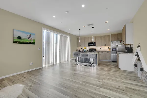 a kitchen with stainless steel appliances a refrigerator and a stove top oven