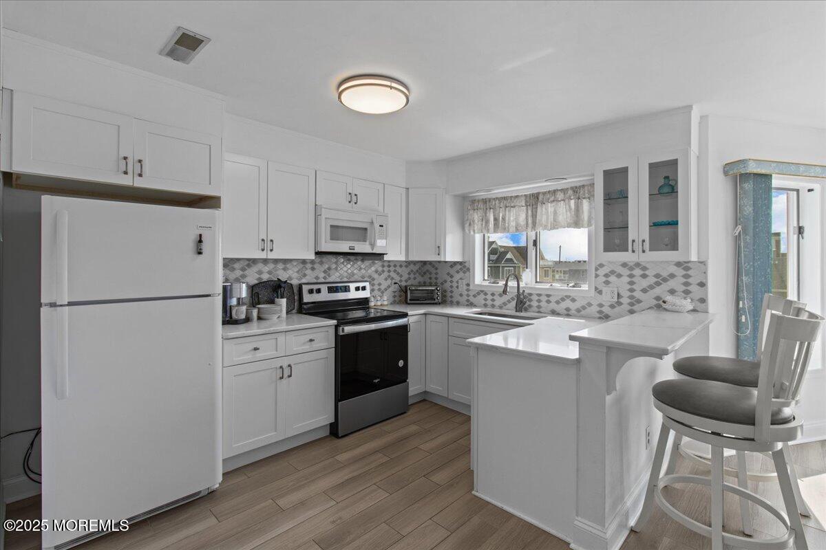 30 Dune Terrace Seaside Heights, NJ 08751 - Photo 13 of 42 a kitchen with cabinets stainless steel appliances and a window