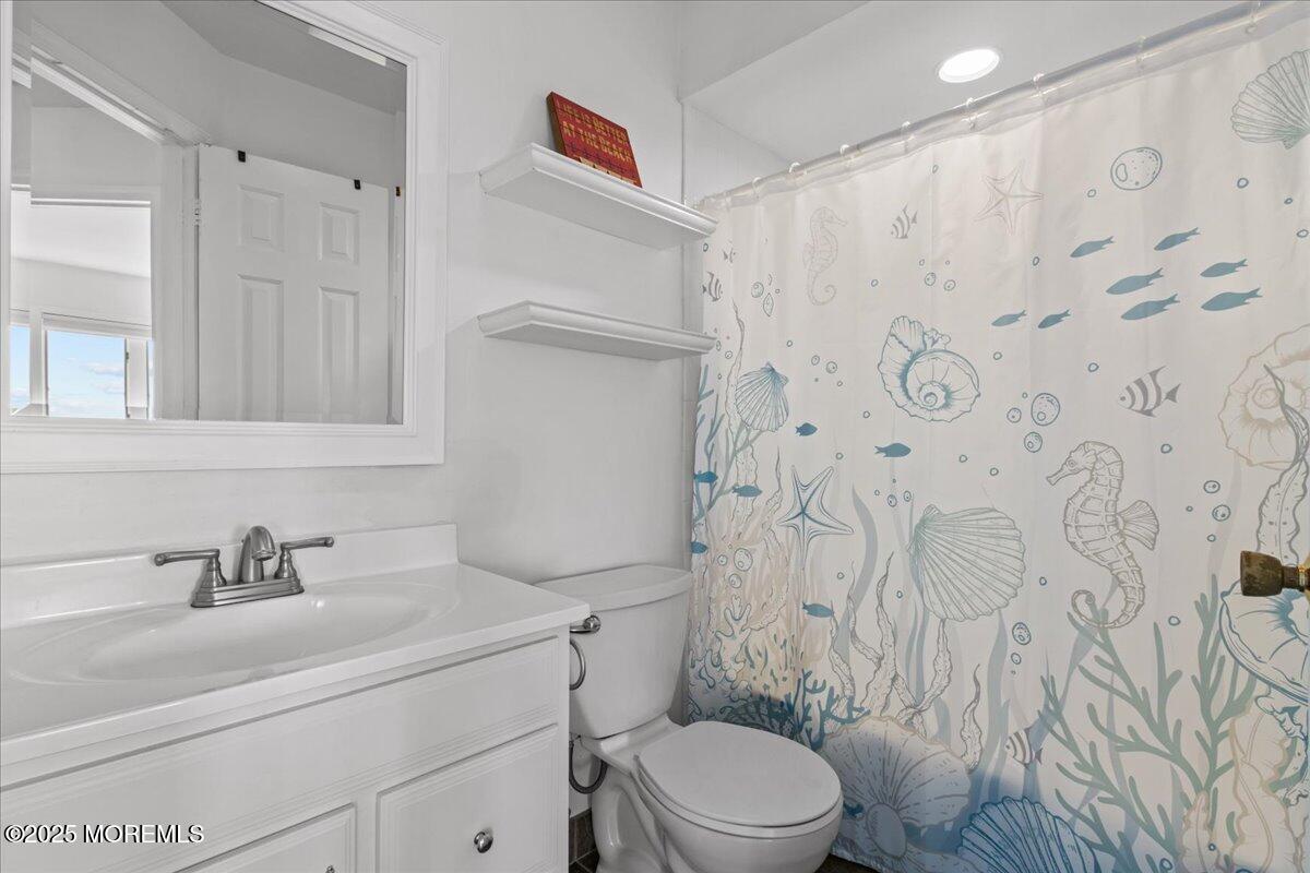 30 Dune Terrace Seaside Heights, NJ 08751 - Photo 18 of 42 a bathroom with a sink a toilet and shower curtain