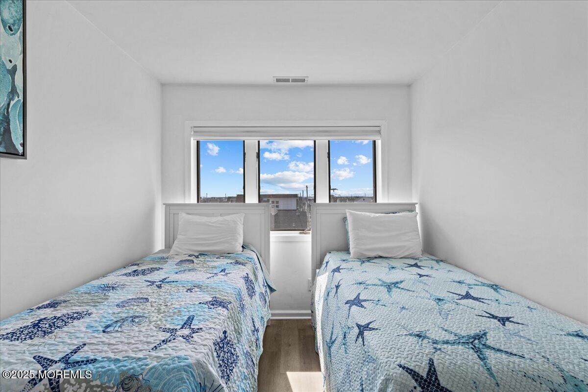 30 Dune Terrace Seaside Heights, NJ 08751 - Photo 19 of 42 a bedroom with two beds and a window