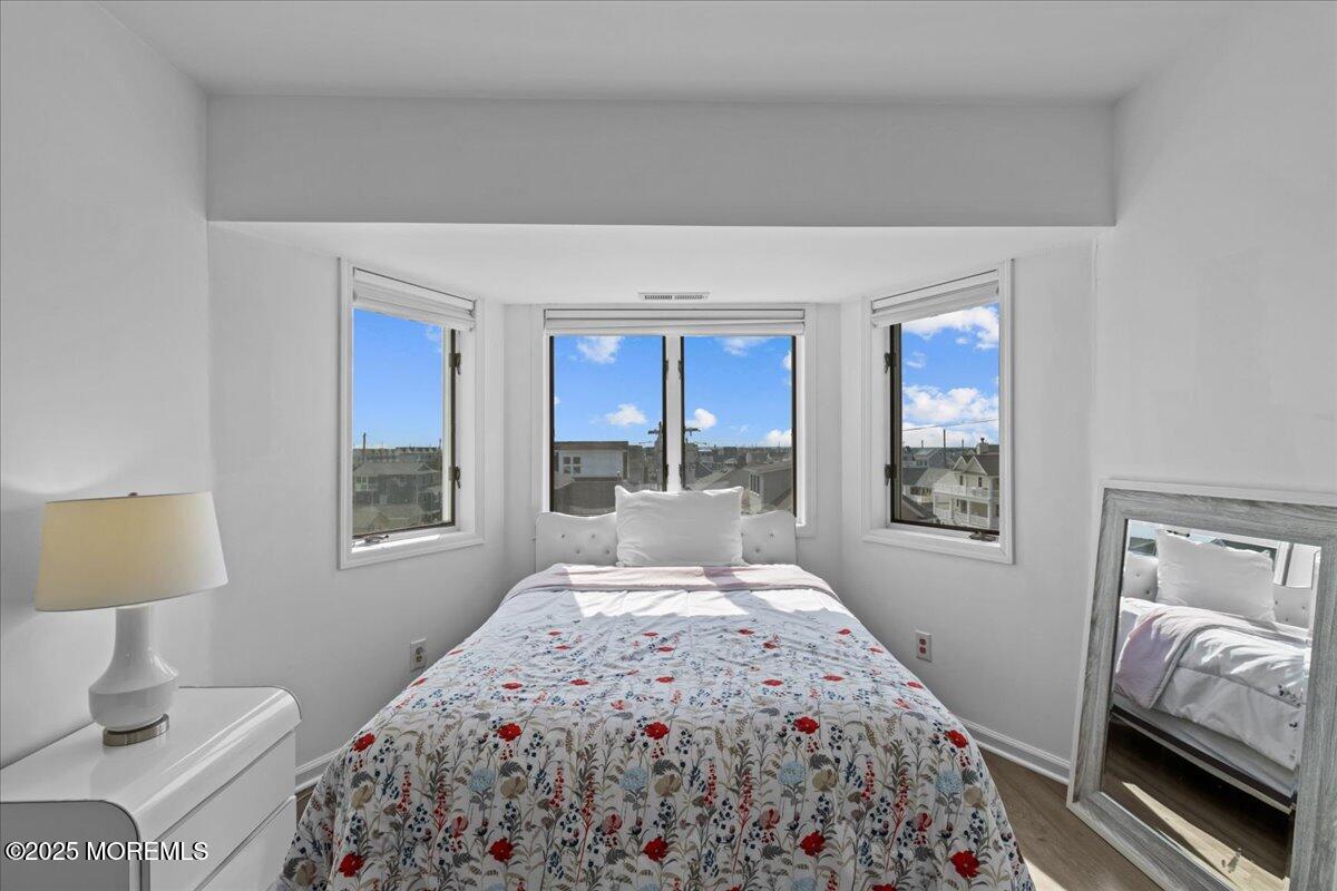 30 Dune Terrace Seaside Heights, NJ 08751 - Photo 20 of 42 a bedroom with a large bed and a window
