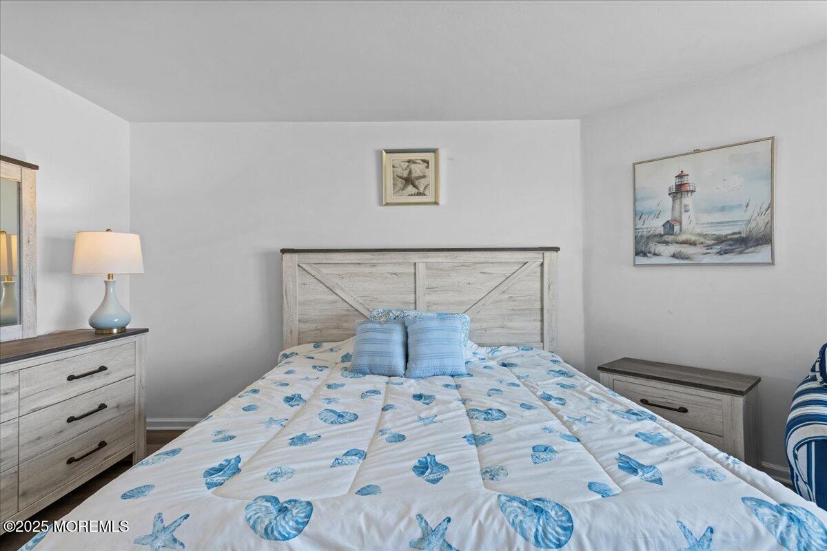 30 Dune Terrace Seaside Heights, NJ 08751 - Photo 34 of 42 a bedroom with a bed and a lamp on dresser