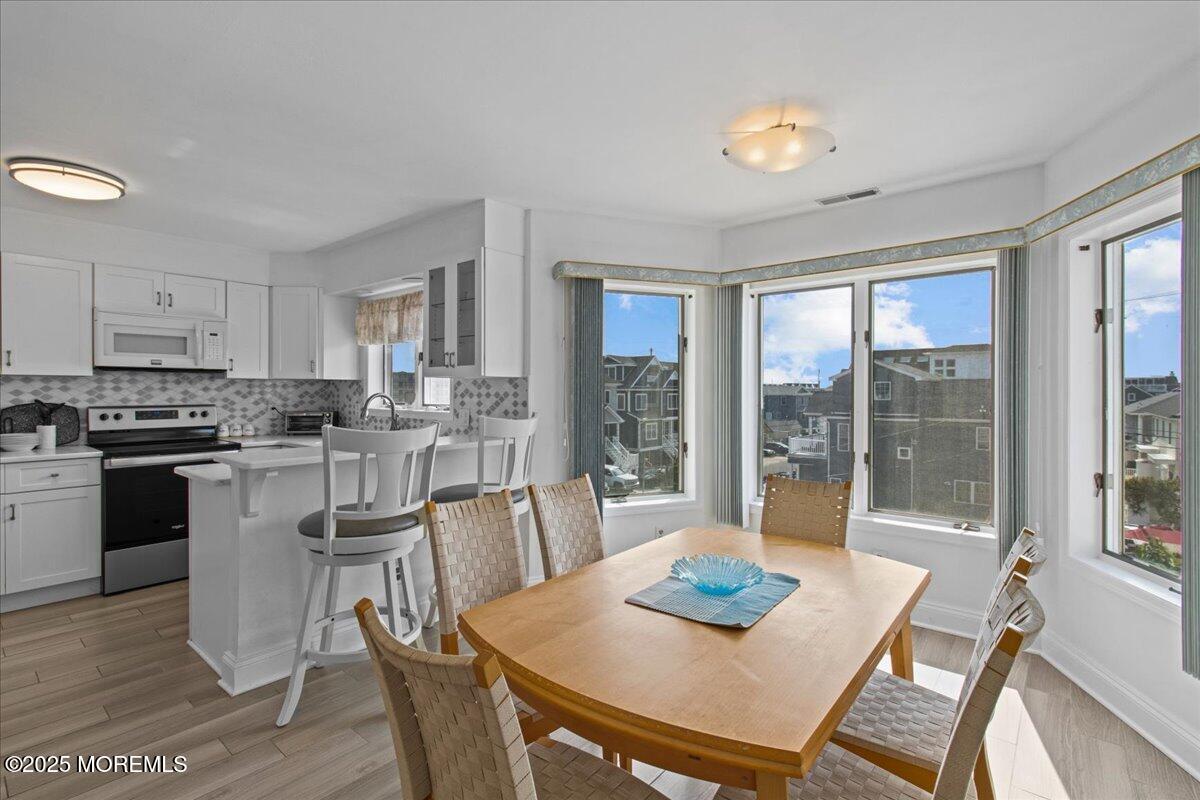 30 Dune Terrace Seaside Heights, NJ 08751 - Photo 9 of 42 a kitchen with a table chairs and wooden floor