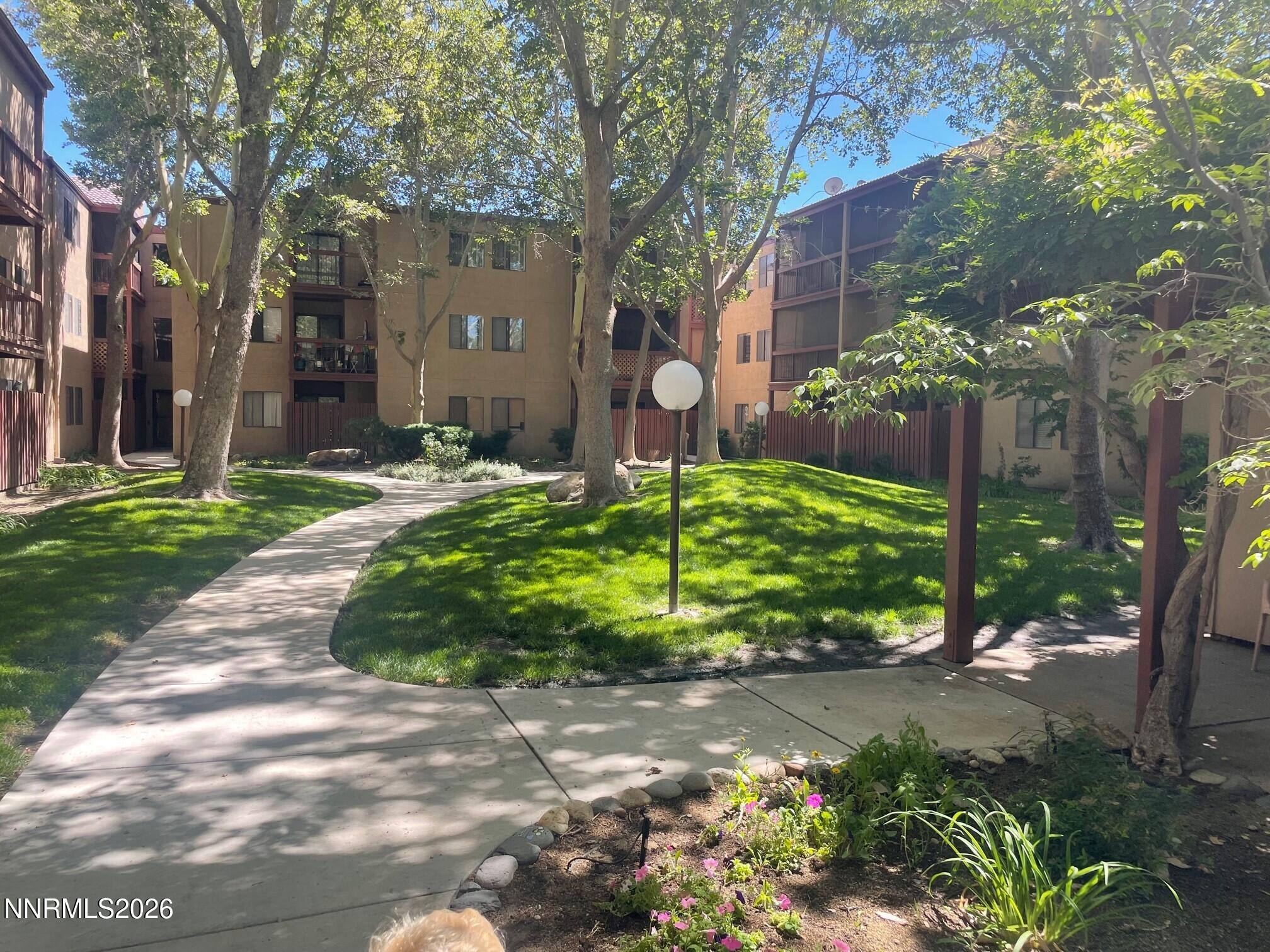 2955 Lakeside Drive, Unit 120 Reno, NV 89509 - Photo 20 of 21 a backyard of a house with lots of green space