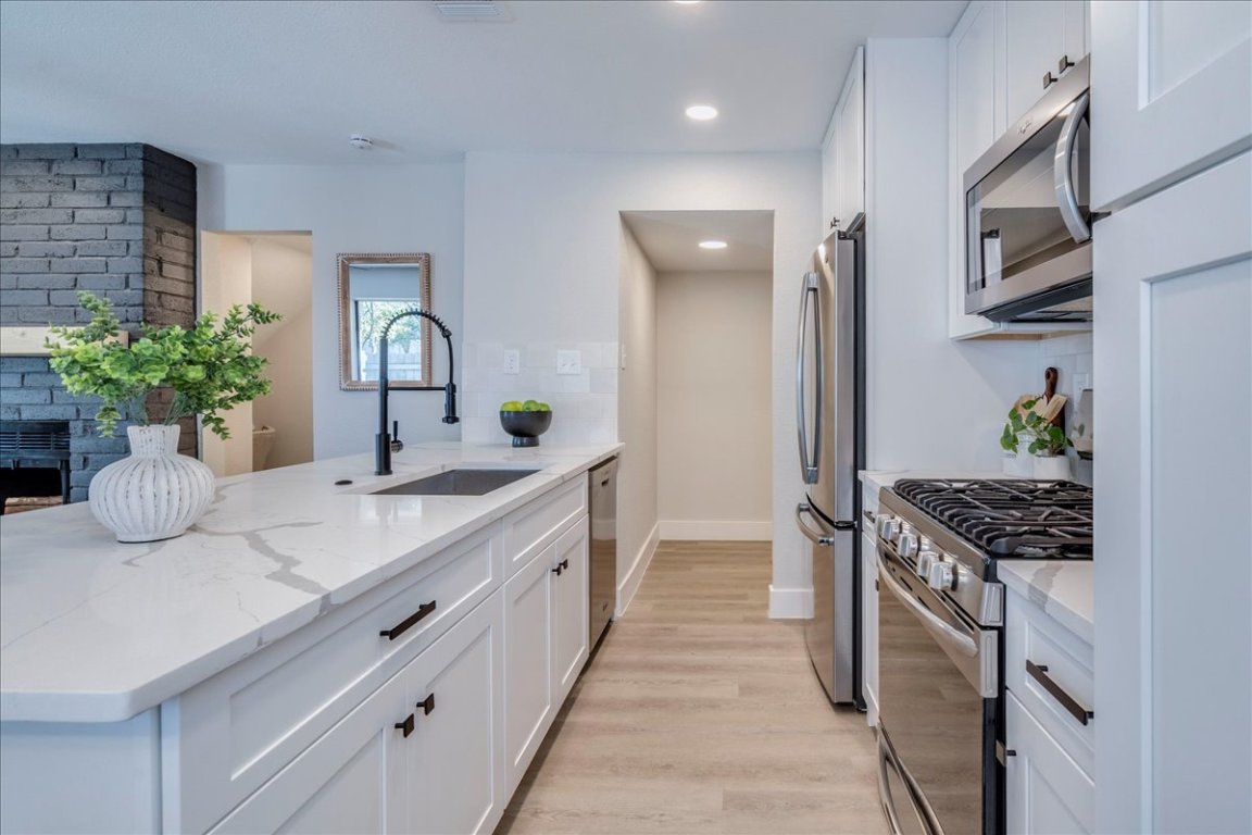 11301 Jollyville Road, Unit F2 Austin, TX 78759 - Photo 9 of 29 a kitchen with a sink and stove