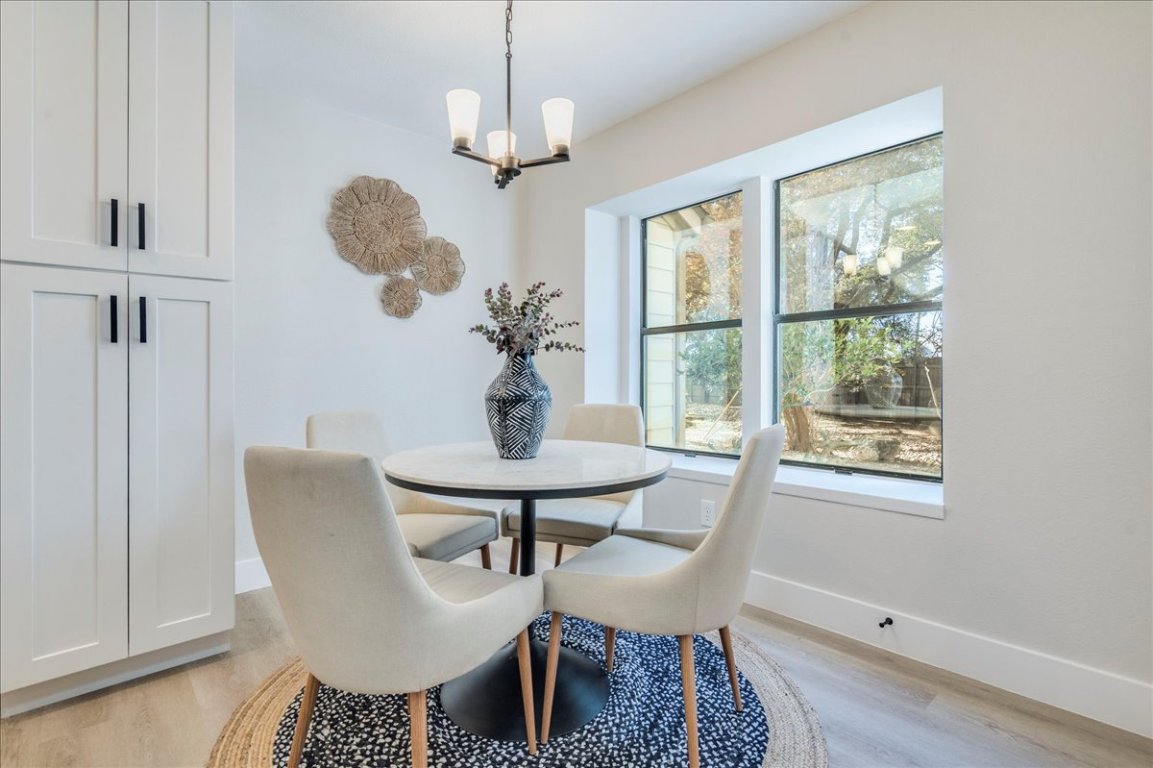 11301 Jollyville Road, Unit F2 Austin, TX 78759 - Photo 10 of 29 a view of a dining room with furniture window and wooden floor