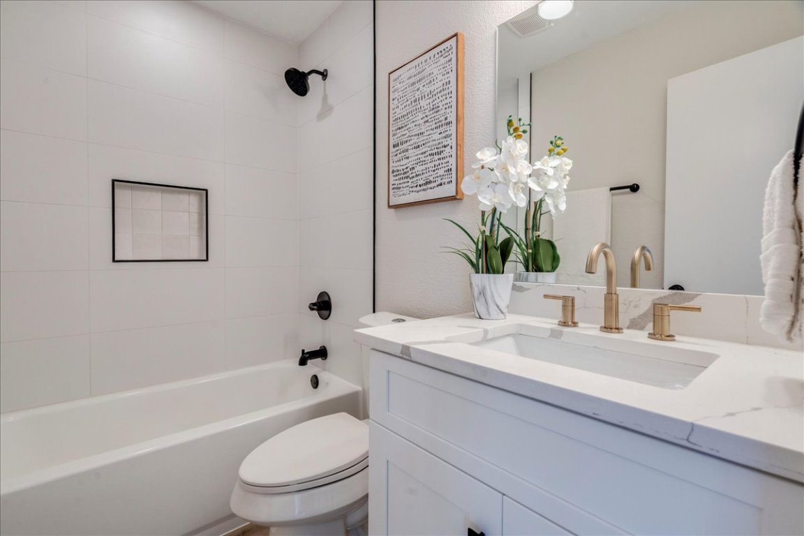 11301 Jollyville Road, Unit F2 Austin, TX 78759 - Photo 14 of 29 a bathroom with a granite countertop sink a toilet and shower