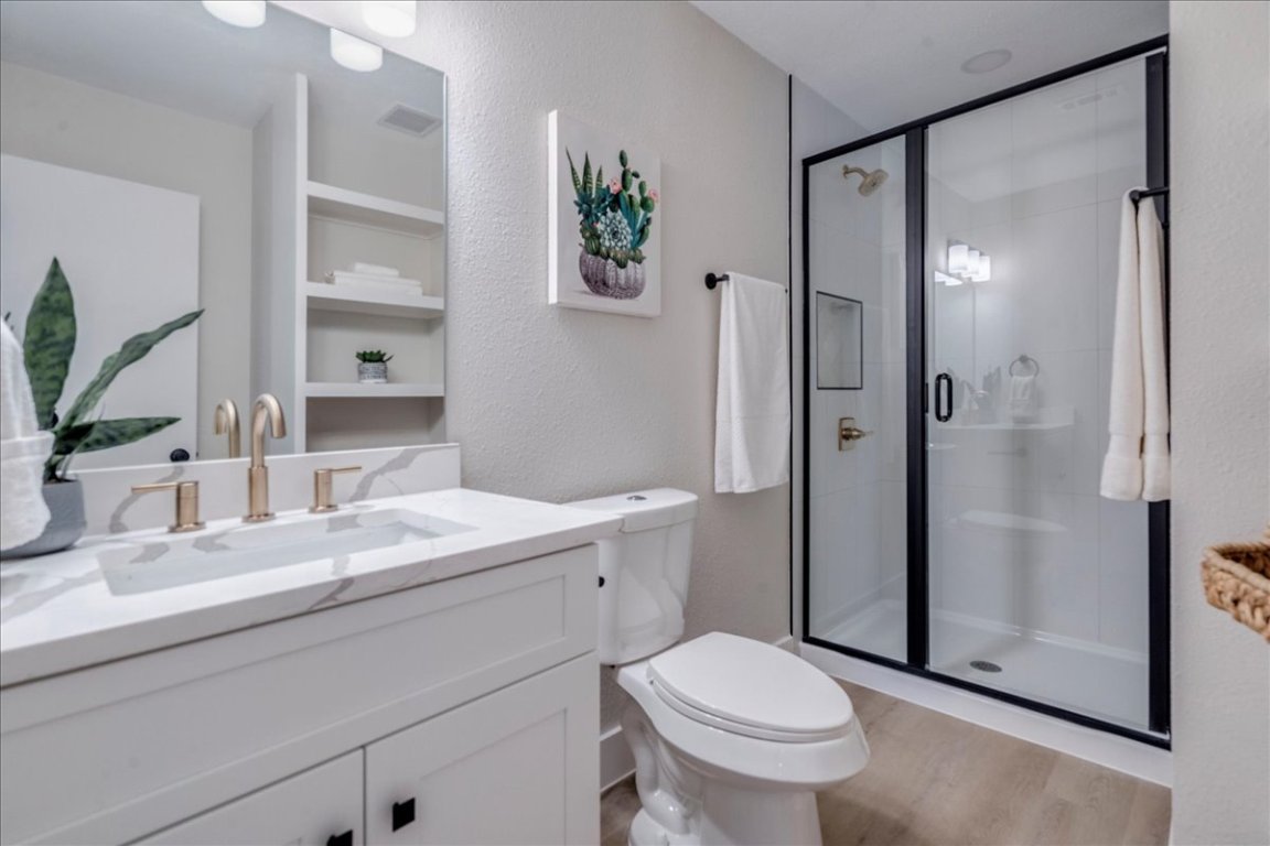 11301 Jollyville Road, Unit F2 Austin, TX 78759 - Photo 17 of 29 a bathroom with a sink a toilet and shower