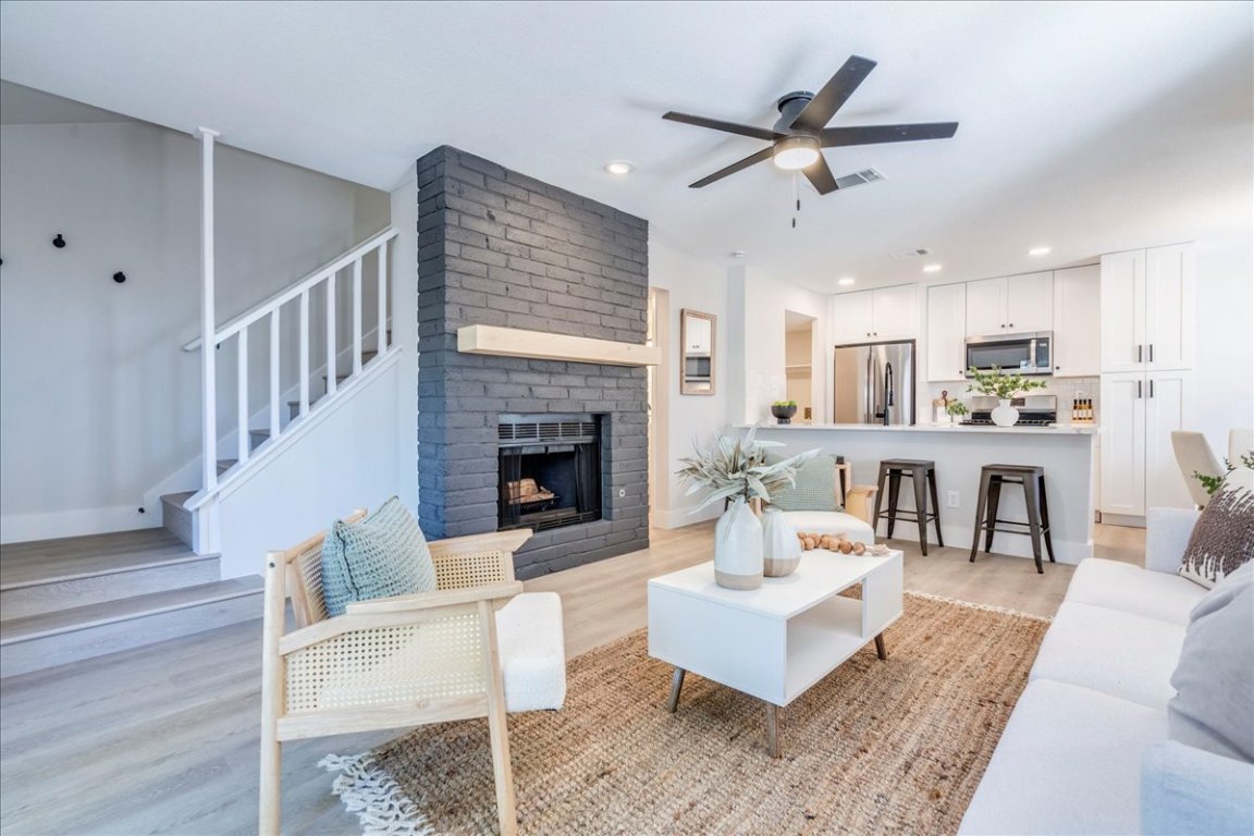 11301 Jollyville Road, Unit F2 Austin, TX 78759 - Photo 6 of 29 a living room with furniture and a fireplace