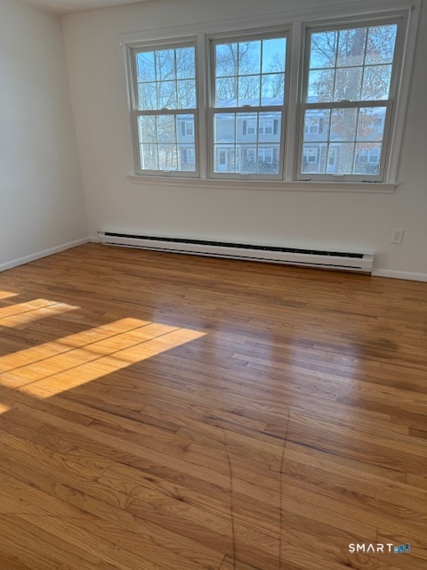 280 East Main Street, Unit E2 Clinton, CT 06413 - Photo 12 of 20 The primary bedroom has hardwood floors. Three windows allow lots of natural light.