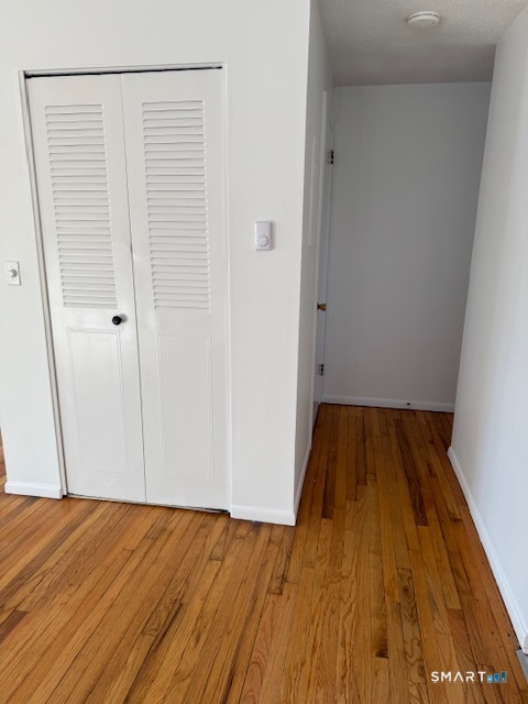 280 East Main Street, Unit E2 Clinton, CT 06413 - Photo 7 of 20 A coat closet is in the living room near hallway to the powder room. Stairs to basement are to the left.