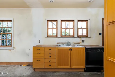 a view of a kitchen with granite countertop cabinets and window