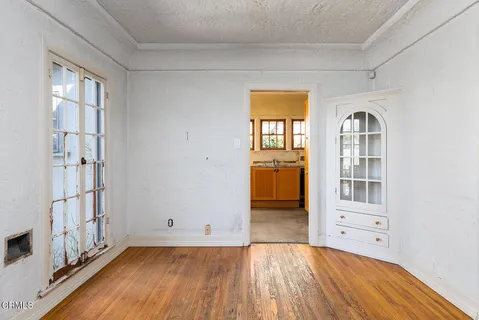 a view of a room with wooden floor and windows