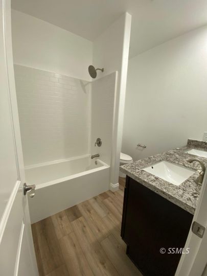 1045 Ocean Avenue Ridgecrest, CA 93555 - Photo 12 of 12 a bathroom with a granite countertop sink a toilet and shower