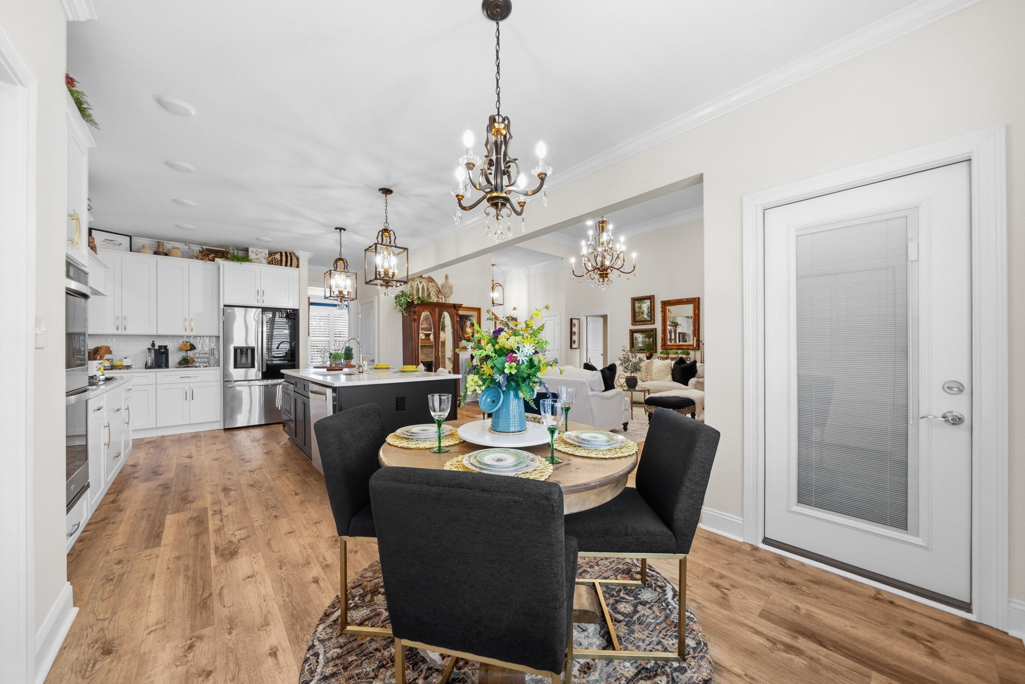 1457 Collins View Way Clarksville, TN 37043 - Photo 13 of 48 a view of a dining room and livingroom with furniture wooden floor a chandelier