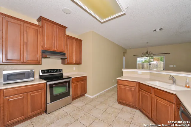 a kitchen with stainless steel appliances granite countertop a sink and cabinets