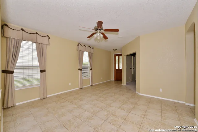 a view of empty room with ceiling fan