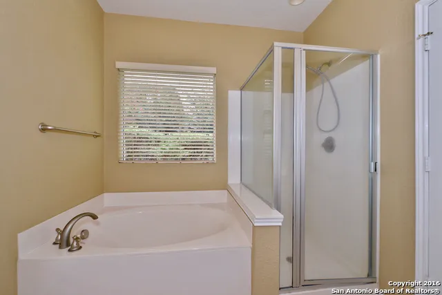 a bathroom with a tub and a shower