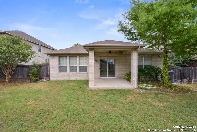 a view of a house with potted plants and large trees